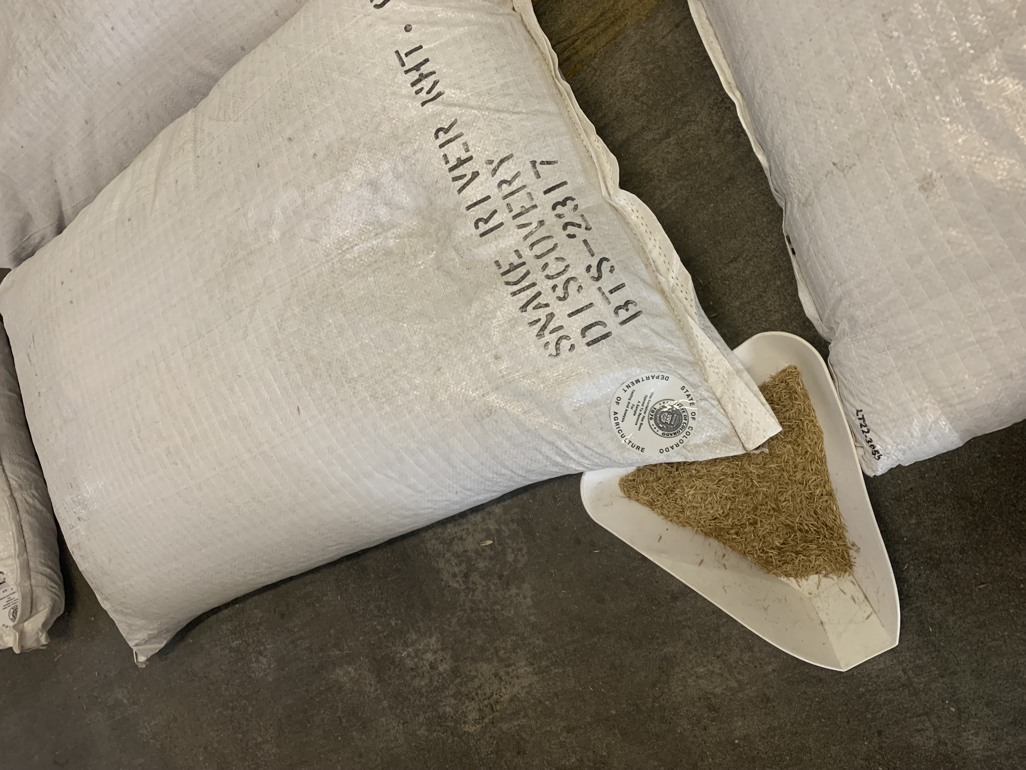 Sealed sack and sample from multiple bags in tray; photo by Cara Meyers, Colorado Department of Agriculture