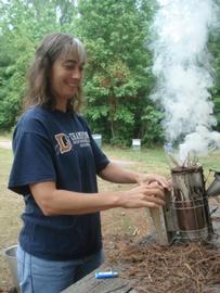  Lighting a smoker; photo by Dewey M. Caron
